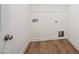 Laundry room with wood-look flooring and connections for a washer and dryer at 73 Artic Cir, Garner, NC 27529