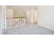Bright hallway featuring neutral carpet, white trim, and an open staircase leading to the upper level at 73 Artic Cir, Garner, NC 27529