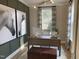 Office features olive green walls, modern lighting and desk with views from a large window at 73 Artic Cir, Garner, NC 27529