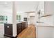 Open kitchen boasts white cabinetry, dark island, stainless appliances, and wood floors at 73 Artic Cir, Garner, NC 27529