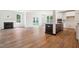 Open-concept living space with fireplace, wood floors, and seamless flow into a modern kitchen at 73 Artic Cir, Garner, NC 27529