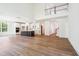 Open floor plan with hardwood floors, large windows and a fireplace at 73 Artic Cir, Garner, NC 27529