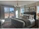Main bedroom featuring large windows, a luxe bed, hardwood floors and designer furnishings at 73 Artic Cir, Garner, NC 27529