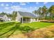 View of the back of the house with a screened-in porch and a lush green lawn at 73 Artic Cir, Garner, NC 27529