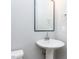 Simple bathroom with modern pedestal sink and framed mirror at 1156 Cottonsprings Dr, Wendell, NC 27591