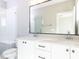 Bathroom features double vanity, modern fixtures, large mirror, and tiled walk-in shower at 1156 Cottonsprings Dr, Wendell, NC 27591