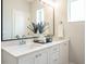 Bright bathroom featuring a double sink vanity, modern fixtures, and a large mirror at 1156 Cottonsprings Dr, Wendell, NC 27591