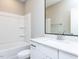 Sparkling bathroom featuring white cabinets, sink, toilet, and a shower-tub combo with shelving for a practical design at 1156 Cottonsprings Dr, Wendell, NC 27591