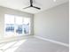 Bright bedroom with a large window, ceiling fan and neutral color palette at 1156 Cottonsprings Dr, Wendell, NC 27591