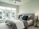 Modern bedroom with a large window providing ample natural light and neutral color palette at 1156 Cottonsprings Dr, Wendell, NC 27591