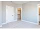 Bedroom featuring a large door to ensuite, a closet, carpet and neutral paint at 1156 Cottonsprings Dr, Wendell, NC 27591