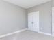 Clean bedroom with a large closet, neutral walls, and plush carpeting for a comfortable, minimalist feel at 1156 Cottonsprings Dr, Wendell, NC 27591