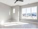 Bright, spacious bedroom with hardwood floors, fan, and ample natural light from large windows offering a neighborhood view at 1156 Cottonsprings Dr, Wendell, NC 27591