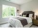 Comfortable bedroom with a large window, allowing ample natural light, and stylish decor at 1156 Cottonsprings Dr, Wendell, NC 27591