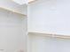 Spacious walk-in closet with wooden rods and shelving for optimal storage at 1156 Cottonsprings Dr, Wendell, NC 27591