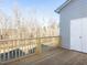 Wooden deck with railing overlooking a wooded area at 1156 Cottonsprings Dr, Wendell, NC 27591