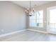Bright dining area with contemporary chandelier and outdoor access at 1156 Cottonsprings Dr, Wendell, NC 27591