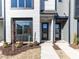 Close-up of modern townhouses, showcasing clean lines, neutral colors, and tidy landscaping for a welcoming curb appeal at 1156 Cottonsprings Dr, Wendell, NC 27591