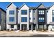 Modern townhomes with a gray, black, and white color scheme, enhanced by large windows and professional landscaping at 1156 Cottonsprings Dr, Wendell, NC 27591