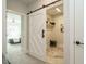 Convenient laundry room with a stylish barn door, built-in shelving, and a modern design at 1156 Cottonsprings Dr, Wendell, NC 27591