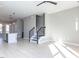 Open-concept living area with hardwood floors, modern lighting, and an easy transition into the kitchen and staircase at 1156 Cottonsprings Dr, Wendell, NC 27591