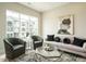 Living room featuring an art piece, comfortable seating, large windows, and modern coffee table at 1156 Cottonsprings Dr, Wendell, NC 27591