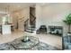 Open living area with modern staircase, a black accent chair, and stylish decor creating a welcoming atmosphere at 1156 Cottonsprings Dr, Wendell, NC 27591