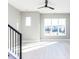 Sunlit living room with large windows and modern black ceiling fan at 1156 Cottonsprings Dr, Wendell, NC 27591
