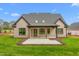 Backyard featuring a covered patio, well-maintained lawn and brick exterior at 3402 St Barts Pl, Mebane, NC 27302