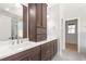 Beautiful bathroom with dark wood cabinets, double sinks, and pristine quartz countertop at 3402 St Barts Pl, Mebane, NC 27302
