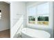 Bright bathroom features a freestanding tub with natural light, creating a spa-like feel at 3402 St Barts Pl, Mebane, NC 27302