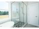 This modern bathroom offers a sleek shower and tub, enhanced by bright natural light at 3402 St Barts Pl, Mebane, NC 27302