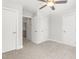 Spacious bedroom with neutral carpet, ceiling fan, and white doors at 3402 St Barts Pl, Mebane, NC 27302
