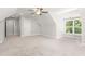 Carpeted room with vaulted ceilings, a fan, and two windows at 3402 St Barts Pl, Mebane, NC 27302