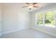 Bright bedroom featuring a ceiling fan, a window with natural light, and white walls at 3402 St Barts Pl, Mebane, NC 27302