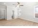 A bright bedroom that features wood-look floors, a ceiling fan, and a view to the bath at 3402 St Barts Pl, Mebane, NC 27302