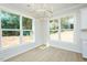 Sunlit dining area with large windows and elegant light fixture at 3402 St Barts Pl, Mebane, NC 27302