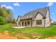 Exterior view showcasing a well-maintained yard and a covered patio at 3402 St Barts Pl, Mebane, NC 27302
