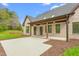 Wide view of the covered patio and the beautifully landscaped backyard at 3402 St Barts Pl, Mebane, NC 27302