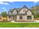 Attractive brick home with dark trim, manicured lawn, and a sidewalk leading to the covered entry at 3402 St Barts Pl, Mebane, NC 27302