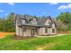 Charming brick home featuring a covered front porch, gable roof, and beautifully landscaped yard at 3402 St Barts Pl, Mebane, NC 27302