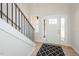 Inviting foyer with white door, sidelights, black accents, and wood-look flooring at 3402 St Barts Pl, Mebane, NC 27302