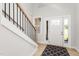 Bright foyer featuring a staircase, patterned rug, and front door with sidelights at 3402 St Barts Pl, Mebane, NC 27302