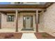 Inviting front porch with brick columns and a welcoming front door with decorative plantings at 3402 St Barts Pl, Mebane, NC 27302