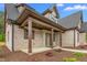 Covered front porch featuring brick columns and well-maintained landscaping at 3402 St Barts Pl, Mebane, NC 27302