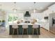 Modern kitchen with island seating, white cabinetry, stainless appliances, and natural light at 3402 St Barts Pl, Mebane, NC 27302