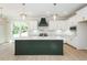 Modern kitchen featuring a large island, white cabinetry, and stainless steel appliances at 3402 St Barts Pl, Mebane, NC 27302