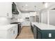 Bright kitchen featuring white cabinets, stone countertops, stainless steel appliances, and a stylish central island at 3402 St Barts Pl, Mebane, NC 27302