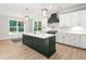 Newly designed kitchen features a large center island, modern appliances, and custom lighting at 3402 St Barts Pl, Mebane, NC 27302
