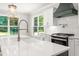 Up close kitchen view with white cabinets, quartz countertops, and stainless steel appliances at 3402 St Barts Pl, Mebane, NC 27302